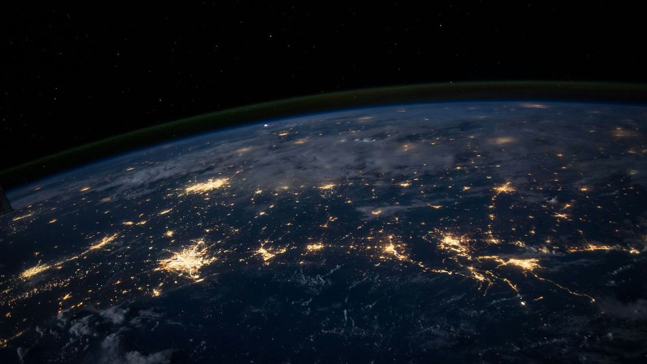 Earth at night seen from space, with city lights